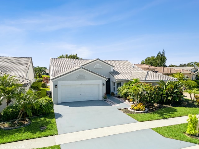 view of front of property featuring a front yard and a garage