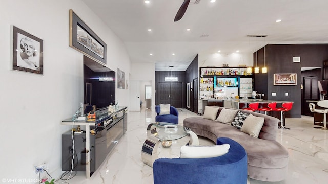 living room featuring bar and ceiling fan