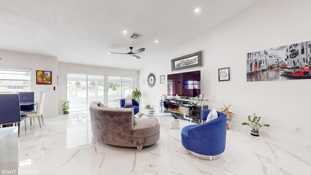 living room featuring ceiling fan, lofted ceiling, and a wealth of natural light