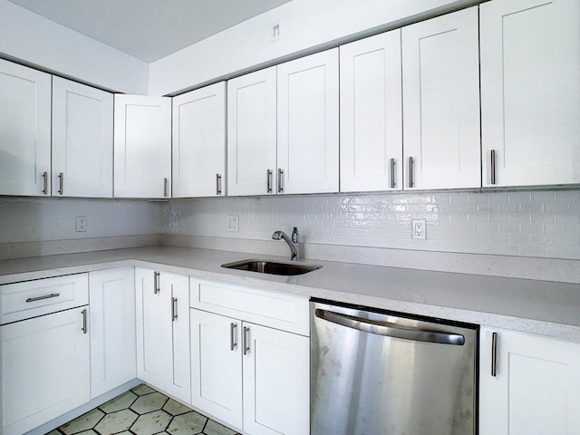 kitchen featuring backsplash, white cabinetry, dishwasher, and sink