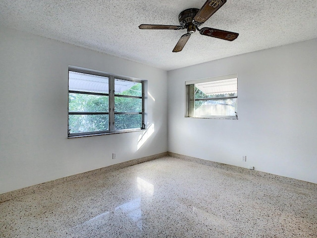 unfurnished room featuring a textured ceiling and ceiling fan