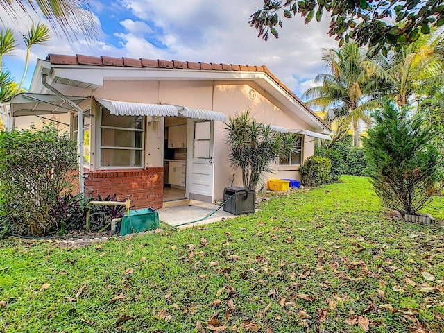 rear view of house with a yard