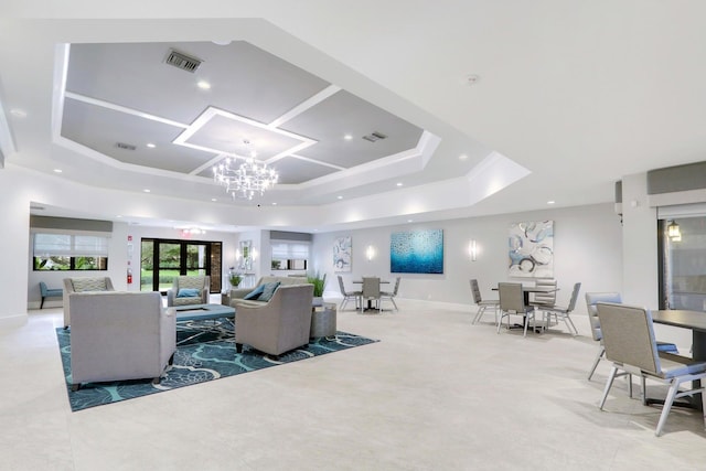 living room featuring french doors, a notable chandelier, and a tray ceiling