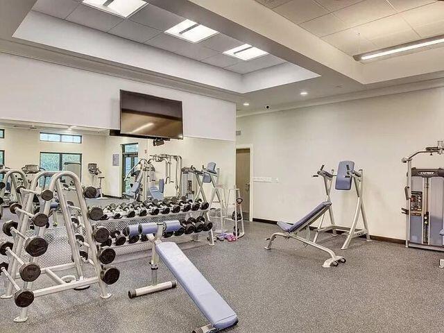 workout area featuring a raised ceiling