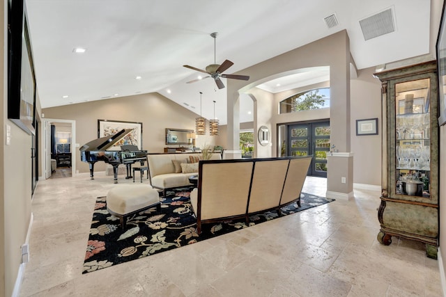 living room featuring vaulted ceiling, ceiling fan, and french doors