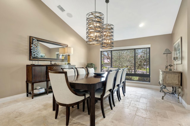 dining space featuring high vaulted ceiling and an inviting chandelier