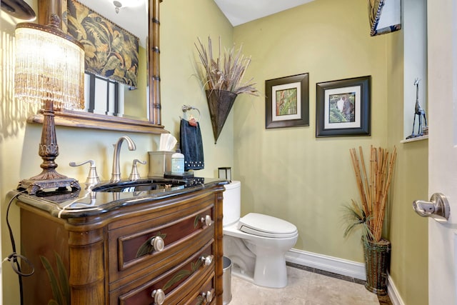 bathroom with vanity, toilet, and tile patterned floors