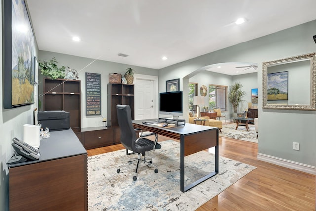 office space featuring light hardwood / wood-style flooring and ceiling fan