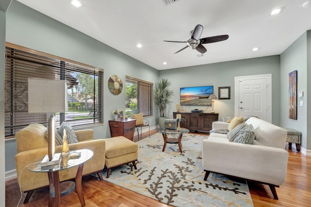 living room with ceiling fan and hardwood / wood-style floors