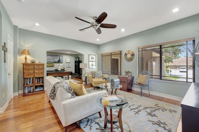 living room featuring ceiling fan and light hardwood / wood-style flooring