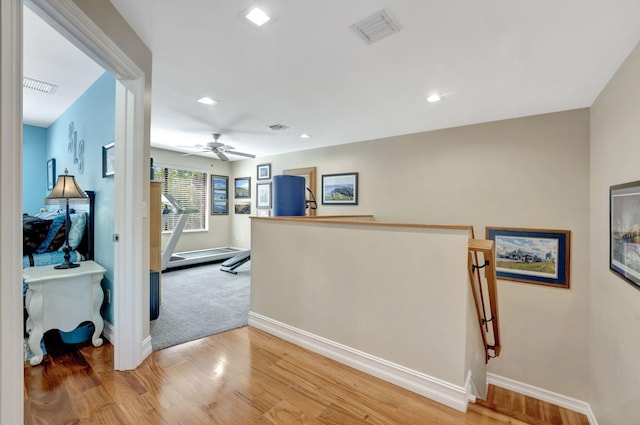 hallway with light hardwood / wood-style floors