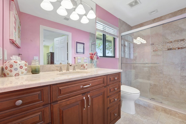 bathroom with tile patterned flooring, vanity, toilet, and an enclosed shower