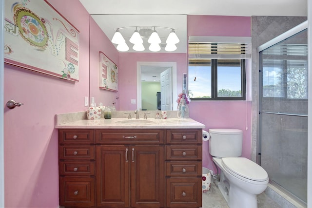 bathroom with vanity, tile patterned flooring, toilet, and a shower with door