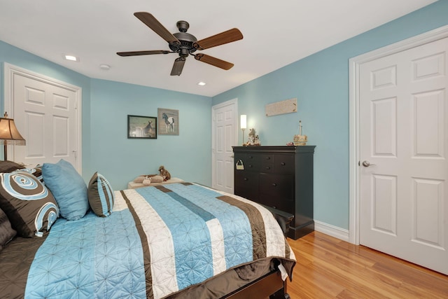 bedroom with light hardwood / wood-style floors and ceiling fan