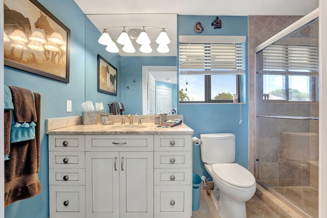 bathroom with tile patterned floors, walk in shower, vanity, and toilet