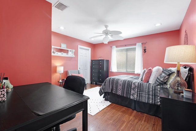 bedroom with ceiling fan and hardwood / wood-style floors