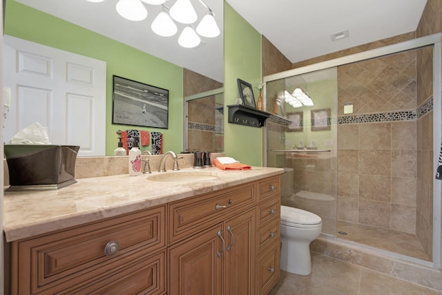 bathroom featuring walk in shower, tile patterned flooring, vanity, and toilet