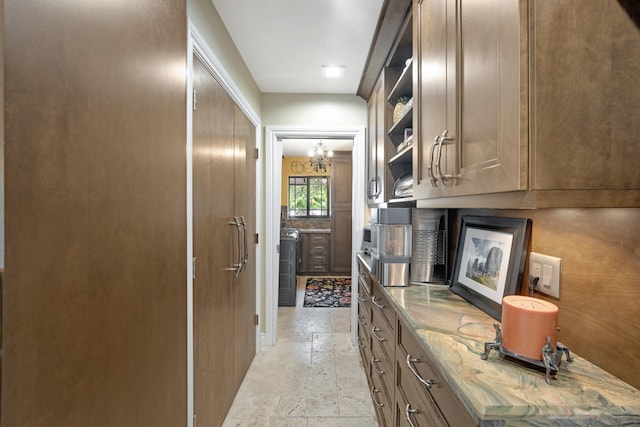 interior space with an inviting chandelier and light stone counters