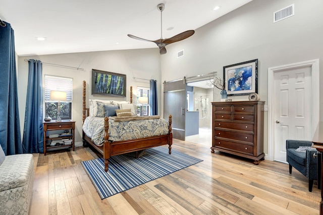 bedroom with ceiling fan, light hardwood / wood-style floors, and high vaulted ceiling