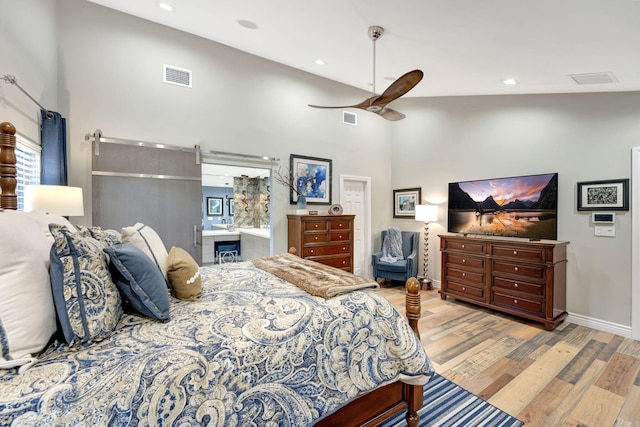 bedroom with light wood-type flooring, ceiling fan, and high vaulted ceiling