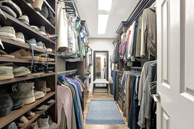 spacious closet with light hardwood / wood-style flooring