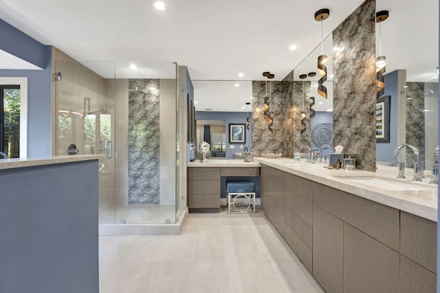 bathroom featuring tile walls, vanity, and a shower with shower door