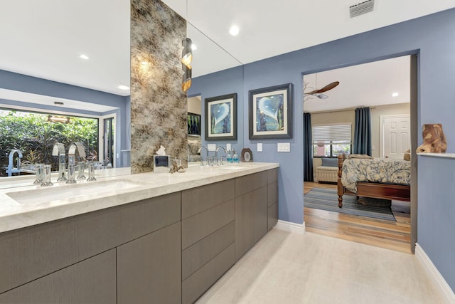 bathroom with ceiling fan, hardwood / wood-style flooring, and vanity