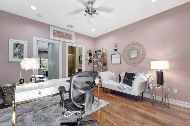 office space with ceiling fan and light hardwood / wood-style flooring