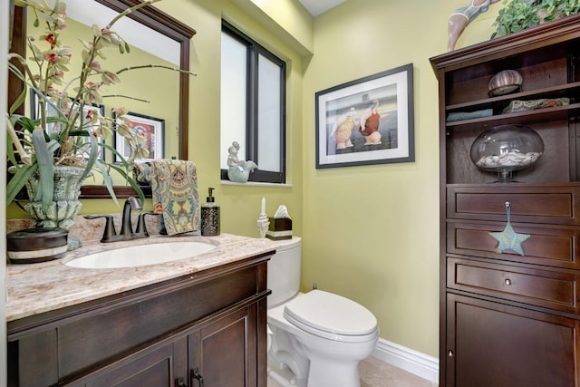 bathroom featuring tile patterned flooring, vanity, and toilet