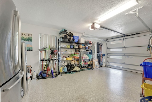 garage with a garage door opener and stainless steel fridge