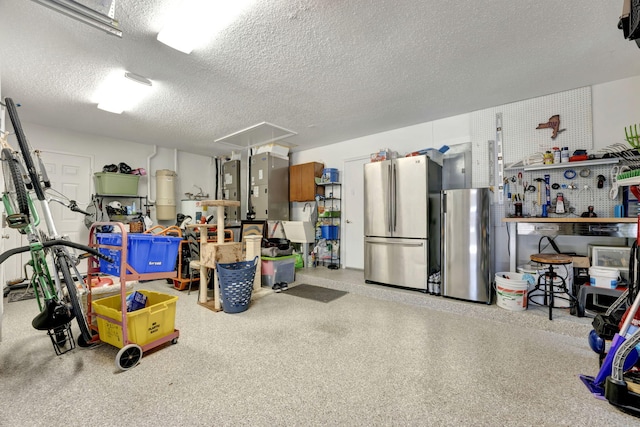 garage featuring strapped water heater and stainless steel fridge