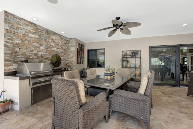 dining space with ceiling fan and sink