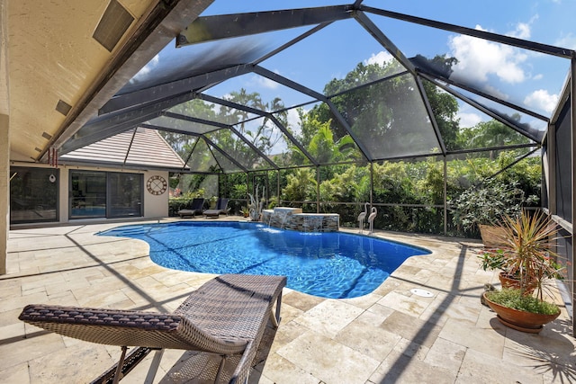 view of pool featuring glass enclosure, a patio, and pool water feature