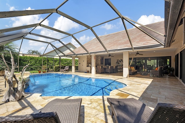 view of swimming pool featuring a patio, a lanai, ceiling fan, and pool water feature