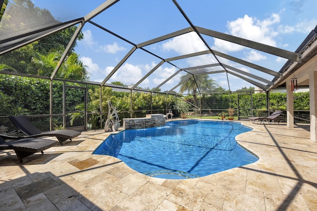 view of pool featuring glass enclosure, a patio, and pool water feature