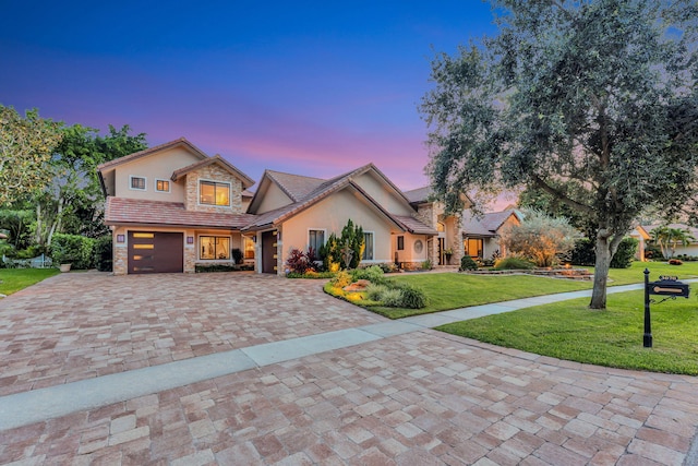 front facade featuring a lawn and a garage