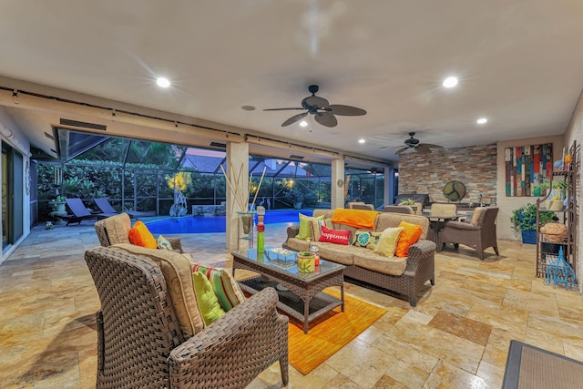 view of patio featuring glass enclosure, outdoor lounge area, and ceiling fan