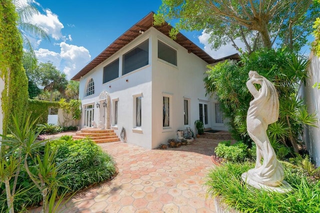 rear view of property featuring a patio area