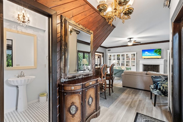 interior space featuring ornamental molding, wood-type flooring, and ceiling fan