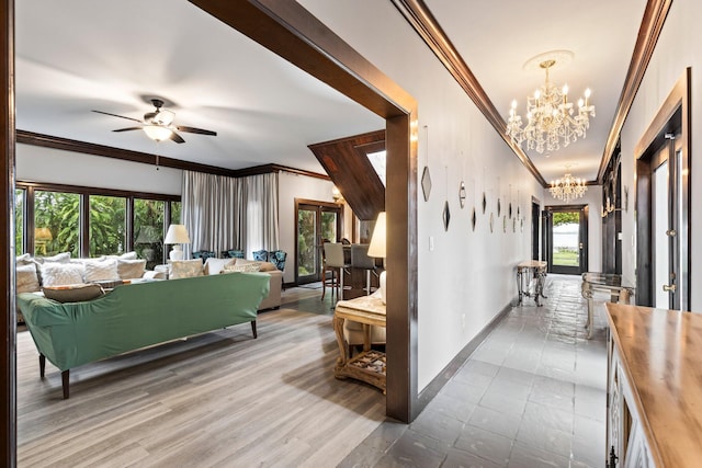 hallway with an inviting chandelier, ornamental molding, hardwood / wood-style floors, and plenty of natural light