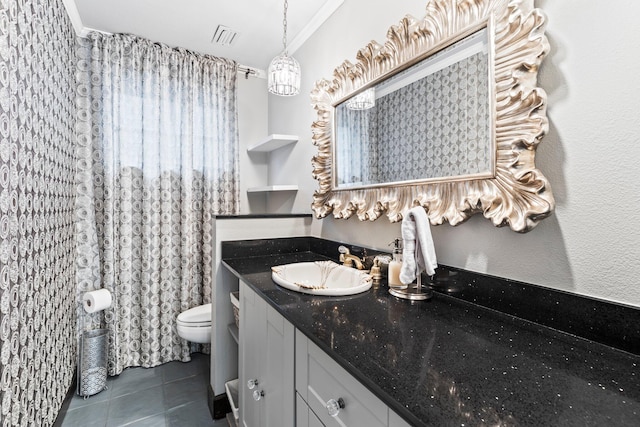 bathroom with vanity, toilet, tile patterned floors, and ornamental molding