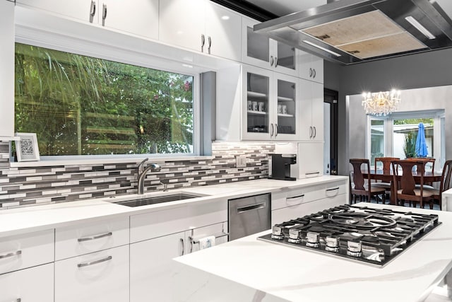 kitchen featuring decorative backsplash, white cabinets, sink, and stainless steel appliances