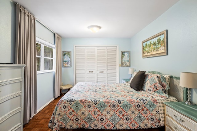 bedroom with a closet and dark parquet flooring