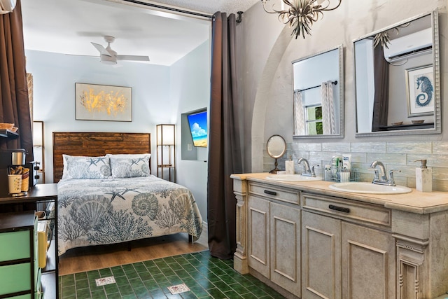 bedroom featuring dark wood-type flooring, ceiling fan, an AC wall unit, and sink