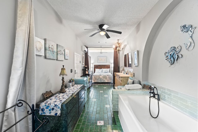 bathroom featuring a tub, a wall mounted AC, ceiling fan, a textured ceiling, and tile patterned flooring