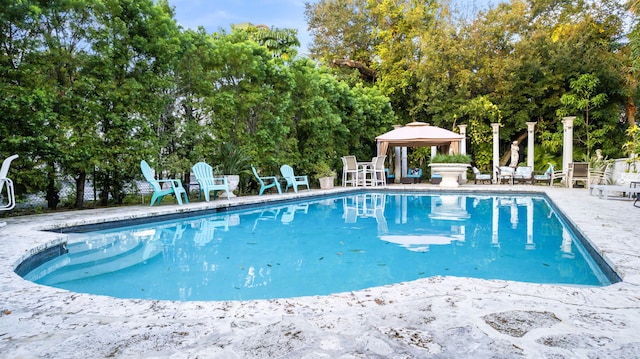 view of pool with a patio and a gazebo