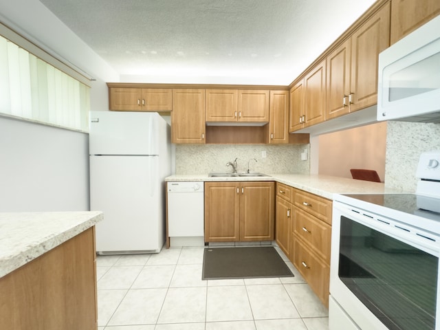 kitchen with decorative backsplash, sink, light tile patterned floors, and white appliances