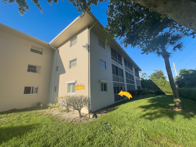 view of property exterior featuring a lawn