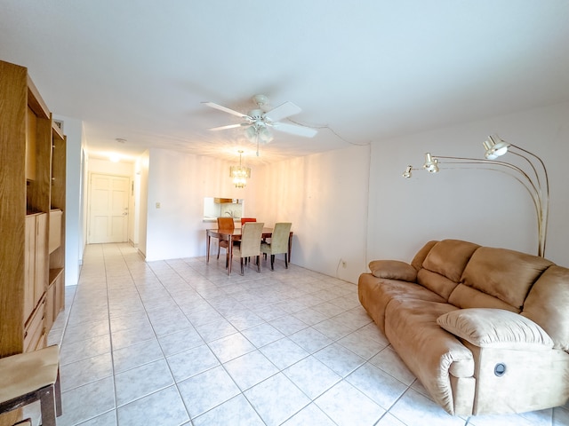 tiled living room featuring ceiling fan with notable chandelier