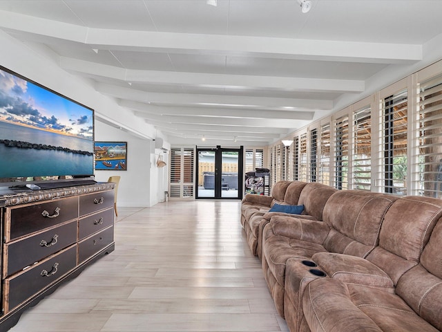 living room featuring french doors, light hardwood / wood-style floors, and beamed ceiling